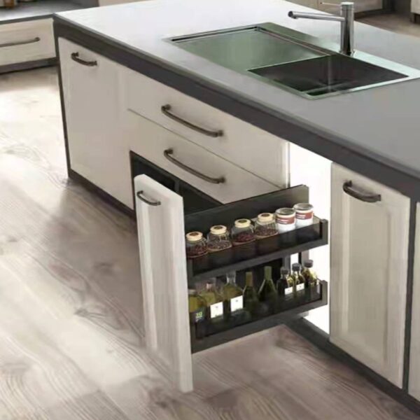 Modern kitchen with a pull-out spice and bottle rack installed in a cabinet near the sink