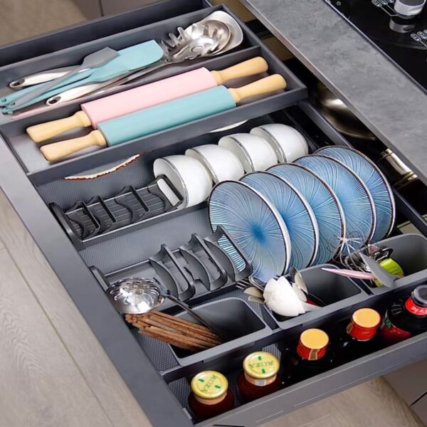 Modern kitchen drawer organizer with dedicated sections for plates, utensils, rolling pins, and condiments.