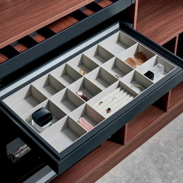 Elegant pull-out jewelry organizer drawer with multiple compartments for rings, watches, and accessories.