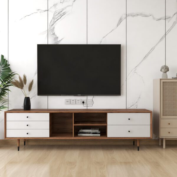 Modern living room featuring a sleek wooden TV cabinet with white drawers, a marble accent wall, a stylish rattan storage cabinet, and decorative plants.